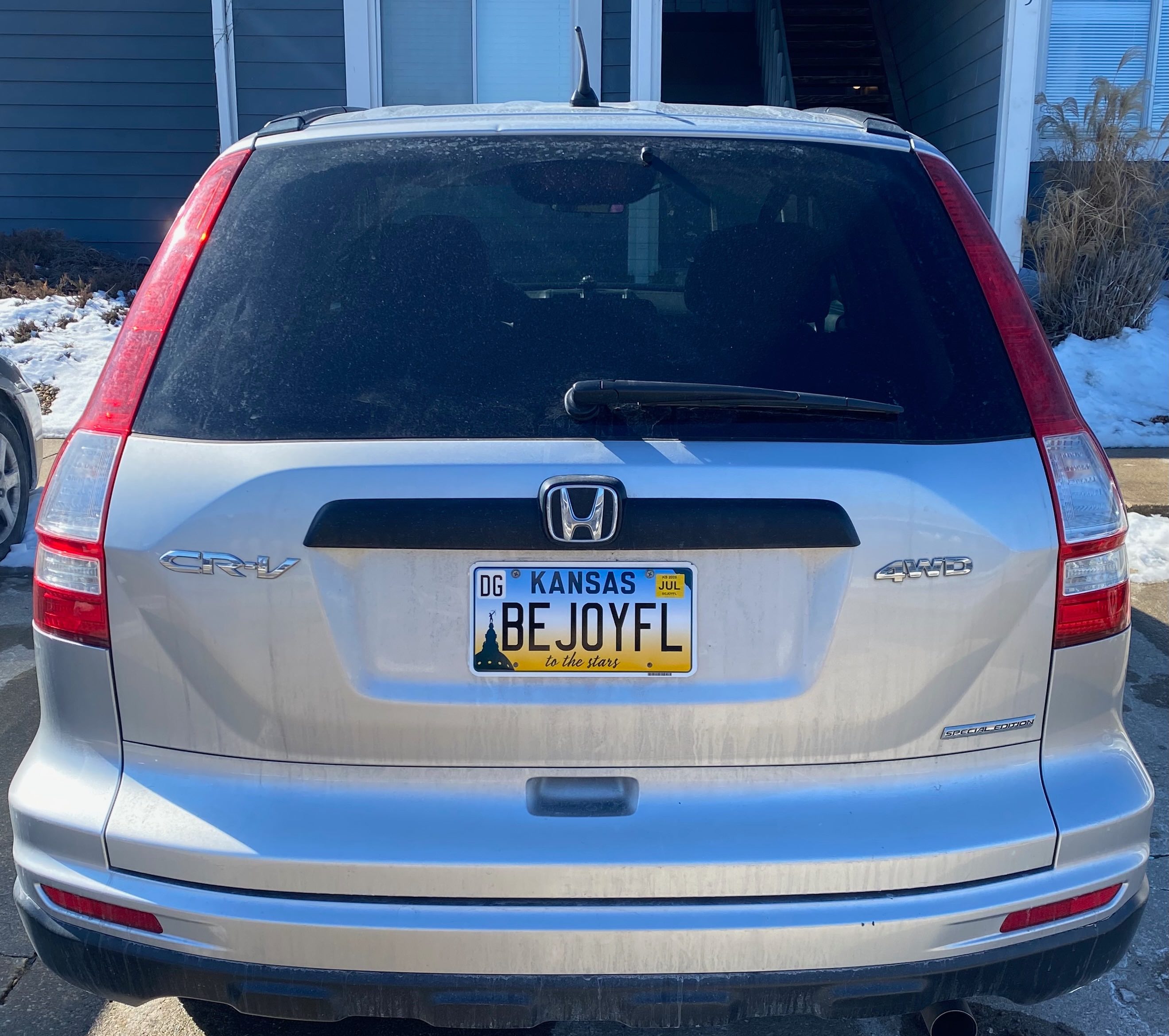 A rear view of my Honda CR-V showing the Kansas license plate with the characters BEJOYFL.