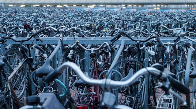 Thousands of bicycles lined up in a bike parking area.