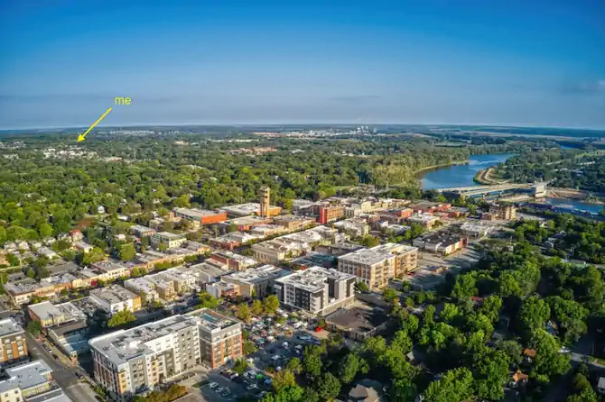 Color photo looking over downtown Lawrence towards the northwest. There is a yellow arrow pointing to the location of my apartment.