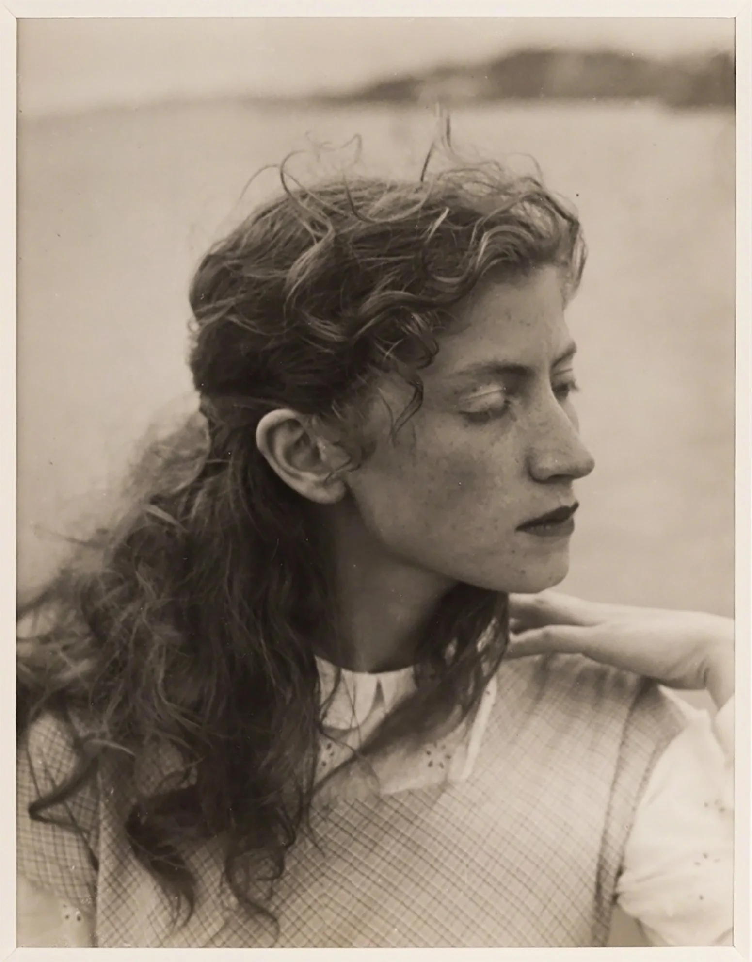 Black and white (sepia) portrait photo of a young woman.