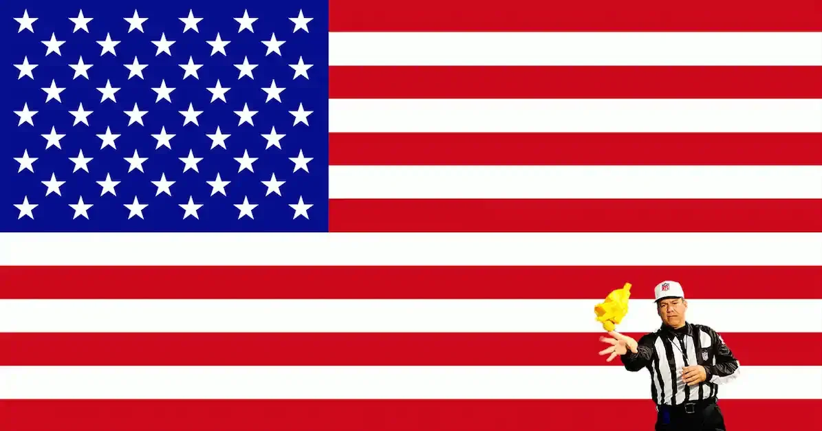 American flag with 50 stars in a blue field, red and white stripes. A referee in the foreground throws a yellow flag, symbolizing a penalty in sports.