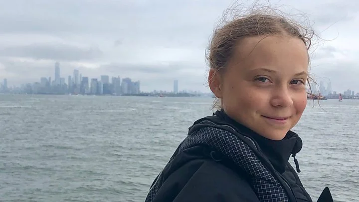 Climate activist Greta Thunberg arriving in New York City after a two-week, zero-emission transatlantic voyage. The photo is taken aboard ship in New York Harbor.
