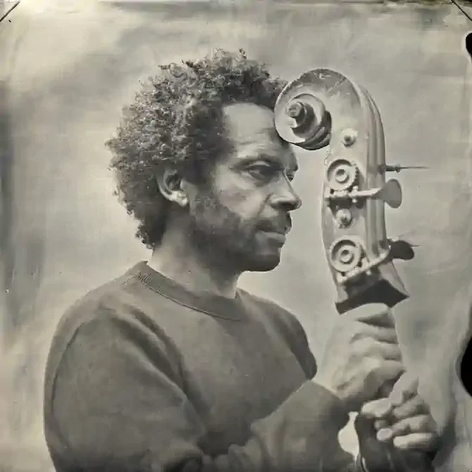 Black and white photo portrait of bassist Kham Meslien.