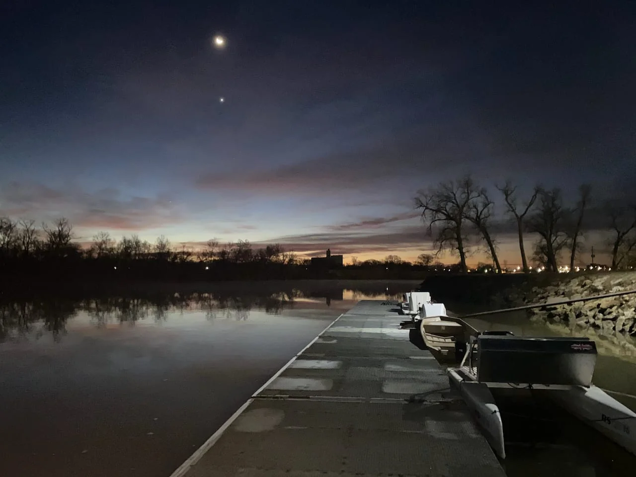 Early morning view of the Kansas Crew dock on the Kansas River. Moon and stars still showing.