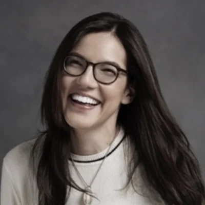 Photographic portrait of Sloane Crosley. Big smile.