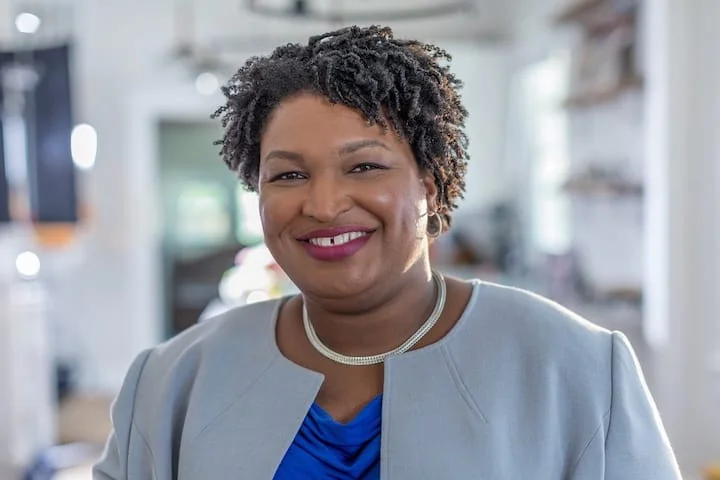 Photographic portrait of a smiling Stacey Abrams