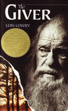 Alt text: "Cover of 'The Giver' by Lois Lowry featuring an elderly man with a long beard looking pensive. A gold medal is embossed, and a sunset-lit forest is seen in a torn section on the lower left."
